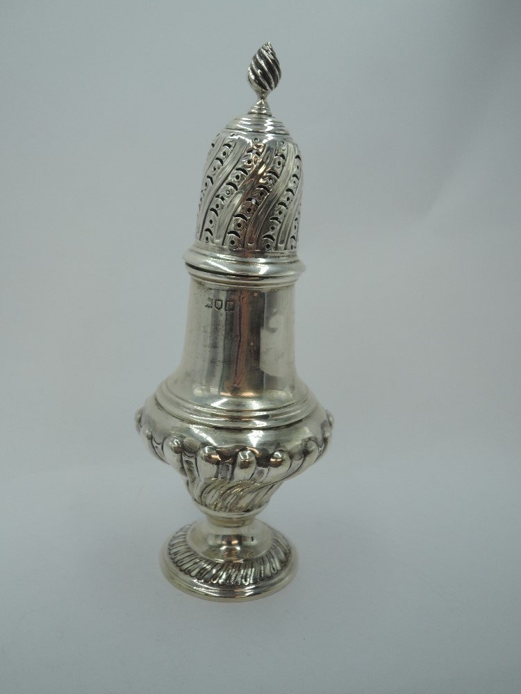 An Edwardian silver sugar caster of baluster form having moulded decoration to body, and pierced