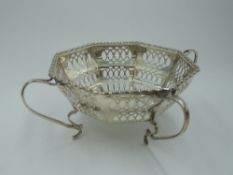 A silver bon bon dish of octagonal form having pierced decoration and four loop handled feet,