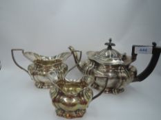 An Edwardian silver three piece tea set of goad form bearing monogram to sides, Birmingham 1904,