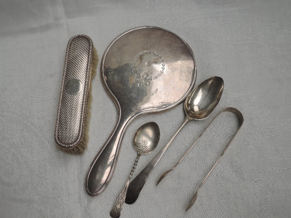 A small selection of HM silver including a hand mirror with ribbon swag decoration, clothes brush