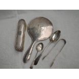 A small selection of HM silver including a hand mirror with ribbon swag decoration, clothes brush