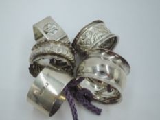 Five HM silver napkin rings of various forms, approx 108g