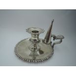 An Edwardian silver chamber stick and snuffer having gadrooned decoration to base rim, sconce and