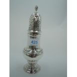 A Georgian silver sugar caster of traditional waisted baluster form having a push on domed lid