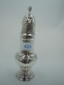 A Georgian silver sugar caster of traditional waisted baluster form having a push on domed lid