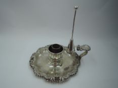 A Georgian silver chamber stick (missing sconce) having facetted saucer with shaped gadrooned rim