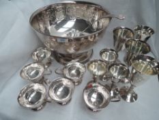 A large silver plated punch bowl having scroll decoration and plain cartouche, with six punch