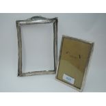 A small silver photograph frame of plain rectangular form having wooden back with easel stand,