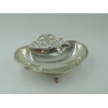 An Edwardian footed bonbon dish having trefoil scallop and paw feet, pierced handle and shaped