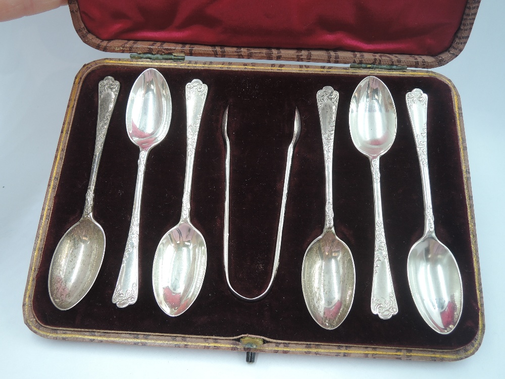 A cased set of Edwardian silver teaspoons and matching sugar nips having moulded decoration to - Image 2 of 2