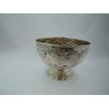 A Victorian silver rose bowl having extensive floral and swag repousse decoration and plain