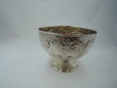 A Victorian silver rose bowl having extensive floral and swag repousse decoration and plain