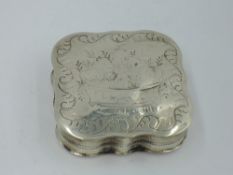 A French silver pill box of canted square form having brightcut and engraved decoration and gilt