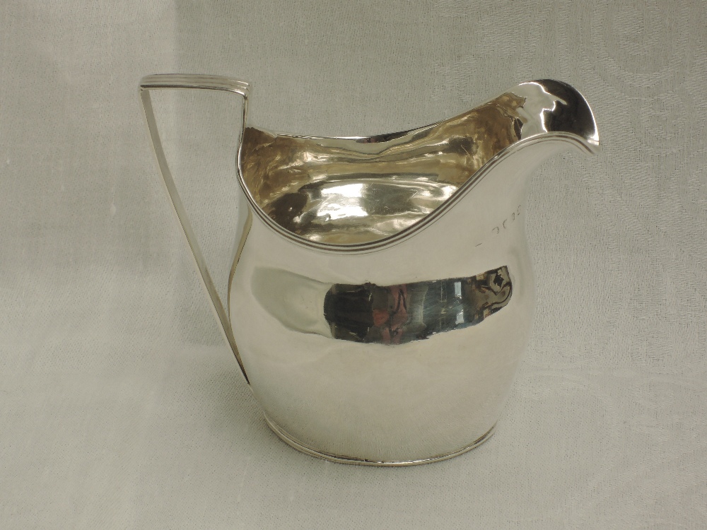 A Georgian silver cream jug of plain helmet style with reeded rim and handle, London 1802, makers - Image 2 of 2