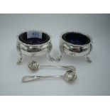 A pair of Georgian silver salts of cauldron form having gadrooned rims, trefoil hoof feet and blue