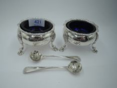 A pair of Georgian silver salts of cauldron form having gadrooned rims, trefoil hoof feet and blue