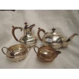 A four piece silver tea set of plain waisted circular form having fruit wood handles and knops,