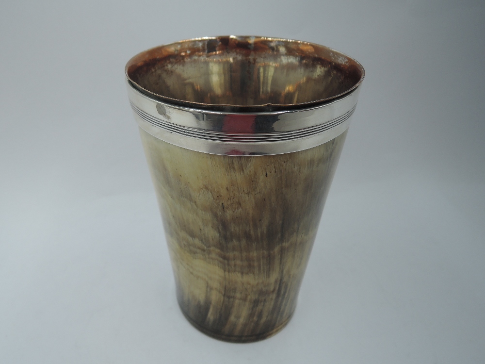 A horn beaker having sheffield plate interior and white metal collar, tests as silver
