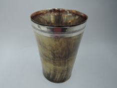 A horn beaker having sheffield plate interior and white metal collar, tests as silver