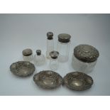 Three small HM silver trinket dishes of boat form having repousse decoration and six glass