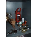 A mixed lot of items including vintage bottle openers, a vice, lighters and more.