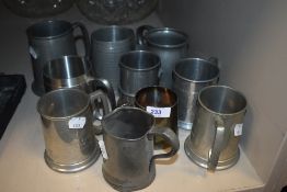 A selection of pewter wares and tankard mugs including Imperial measure