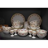 A partial Wearing and Gillow tea service comprising of egg cups,cups and saucers,jug and plates