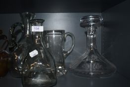 An Auchentoshan decanter having QE2 etched detail, also included are similar jugs and decanters.