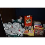 A good quantity of packs of playing cards a vintage tin and a doll.