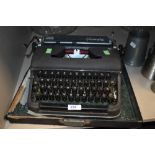 An Olympia typewriter in case olive green