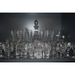 A collection of mixed glassware including etched decanter and a variety of different glasses and