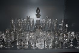 A collection of mixed glassware including etched decanter and a variety of different glasses and