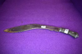 A Indian/Nepalese Kukri having chased detail to blade and inlaid metal work to bone handle.