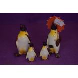 Four Beswick studies, Penguin with Umbrella 802, Penguin with Walking Stick 803, Penguin Chicks