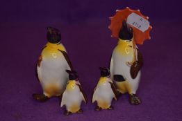 Four Beswick studies, Penguin with Umbrella 802, Penguin with Walking Stick 803, Penguin Chicks