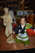 A Japanese Hakata doll of a samurai and similar monk figure