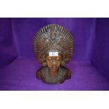 An intricately carved ethnic styled wooden bust.