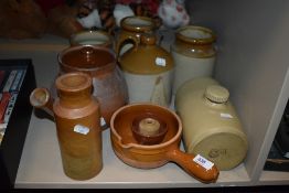 A selection of earthen ware salt glazed jugs and flagons including spouted lidded pot