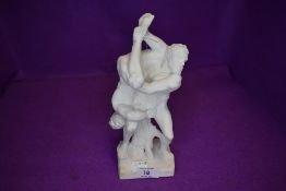 A figure depicting two naked Greek men wrestling.