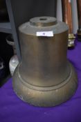 A heavy brass fire bell or similar.