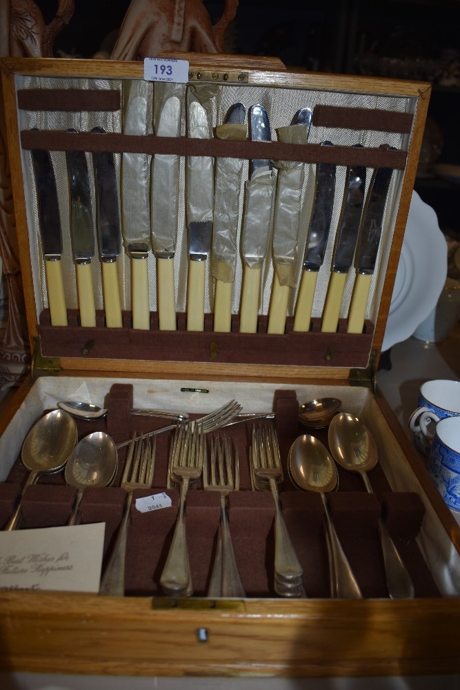 A golden oak cased canteen of cutlery by Cooper Bros and Sons