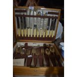 A golden oak cased canteen of cutlery by Cooper Bros and Sons