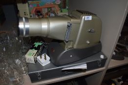 A selection of photographic slides and an Aldis projector lamp