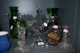 An assortment of art glass, candle sticks and glasses.