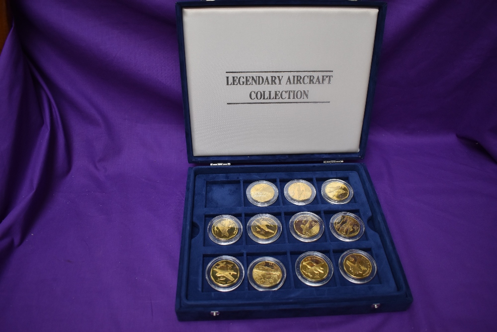 A part set of The Legendary Aircraft Collection of Brass Coins in display case, 11 coins in total