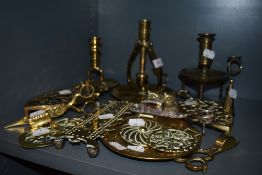 A selection of brass wares including ships chamber stick and bridge counter