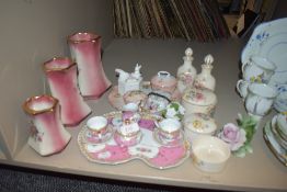 A selection of dressing table items including graduated jug set and storage jars