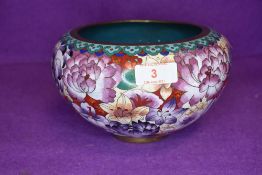 A cloisonne bowl in a millefiori pattern on red and purple ground 20cm wide