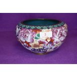 A cloisonne bowl in a millefiori pattern on red and purple ground 20cm wide