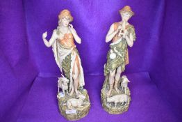 A pair of shepherd figures by Royal Dux having stamp to base one figure having slight damage
